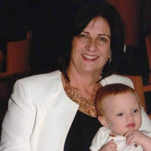 Kathy with a child on her lap.